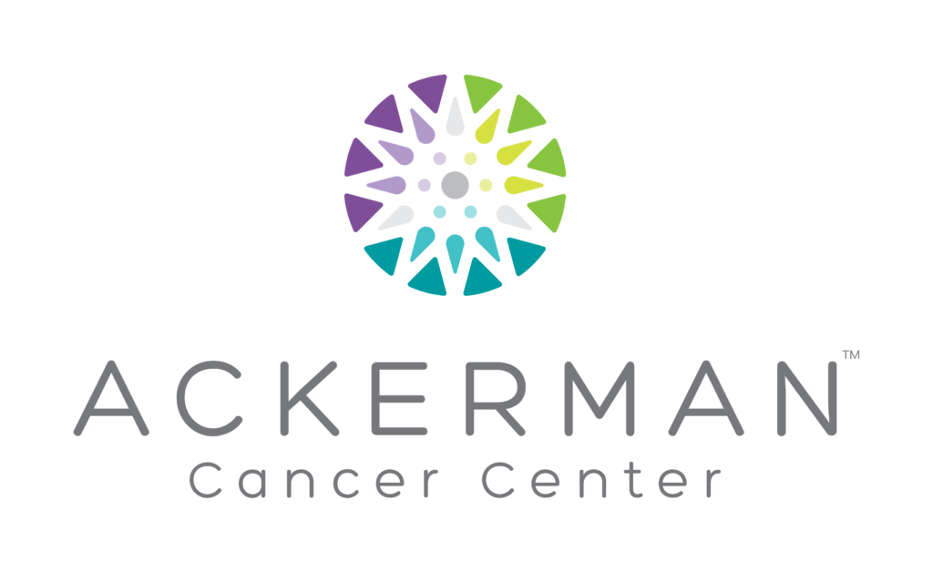 Colorful circular emblem composed of various triangular and teardrop shapes in purple, green, yellow, and blue hues above the text "ACKERMAN" in uppercase gray letters and "cancer center" in lowercase gray letters beneath it.